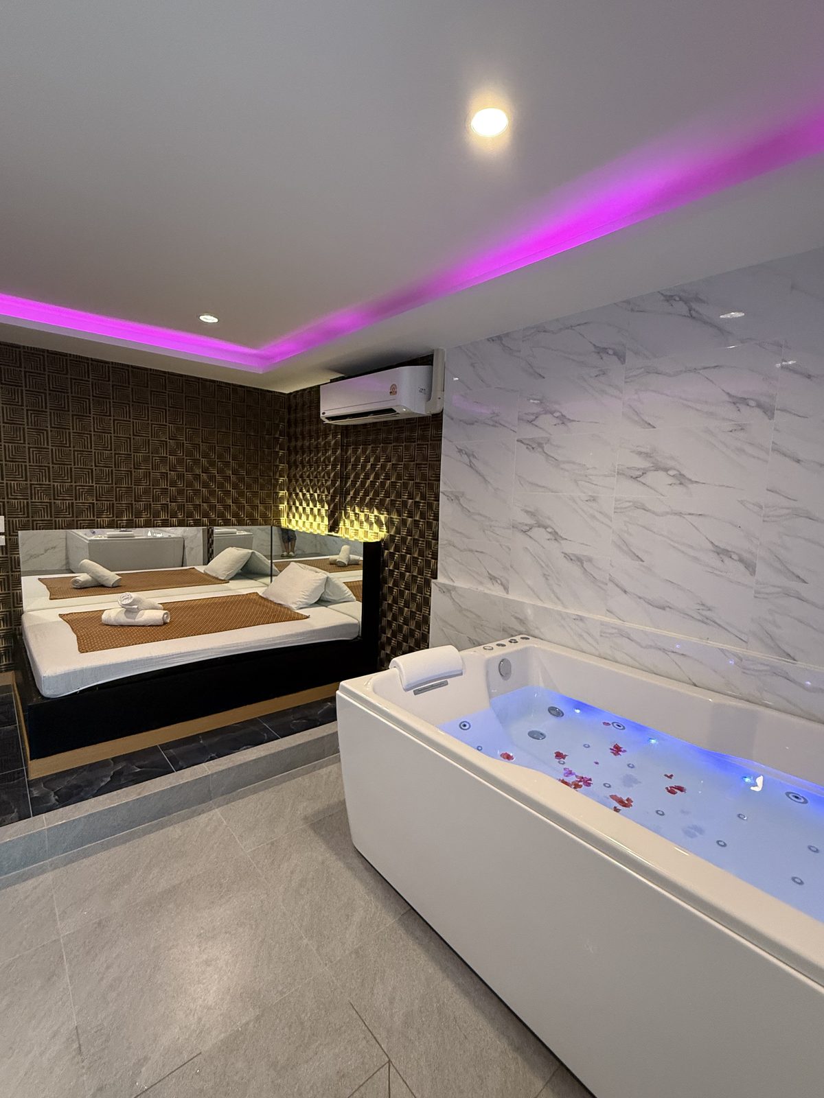 Jacuzzi tub with rose petals in a Boss Massage VIP room